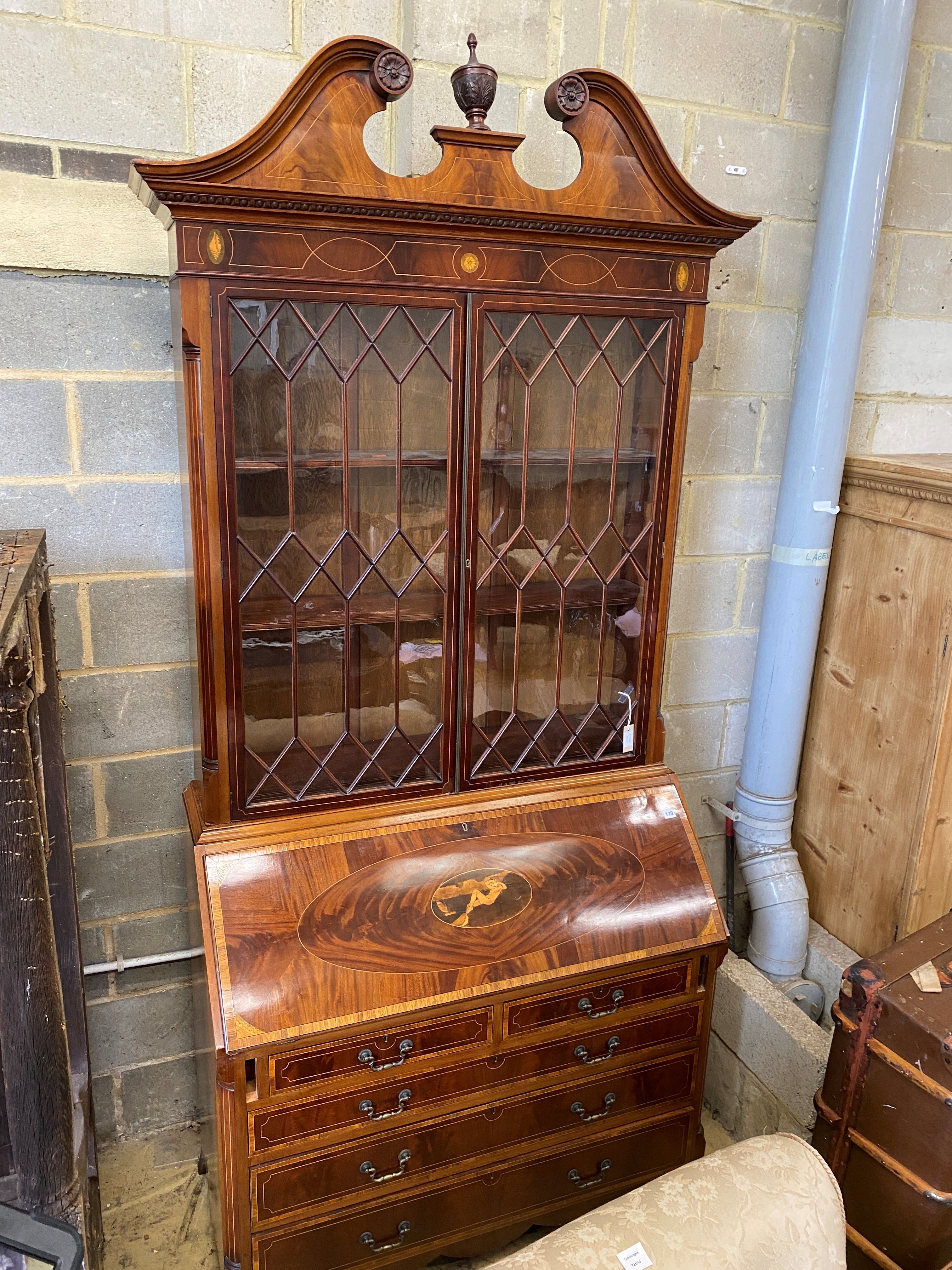 A good quality George III style inlaid and cross banded flamed mahogany bureau bookcase, width 132cm, depth 58cm, height 278cm.